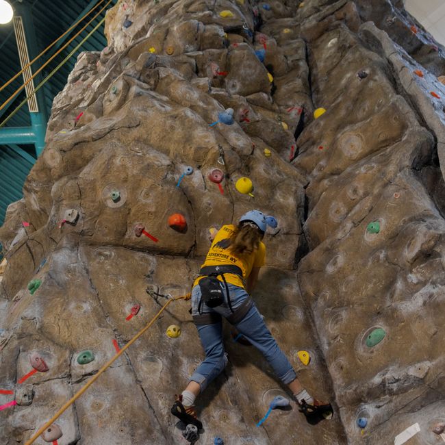 A WVU Student lead climbs on the rock wall at the WVU Student Rec Center. 