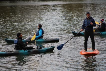Kayakers lead by staff during a guided experience on the Monongahela River in Morgantown, WV.