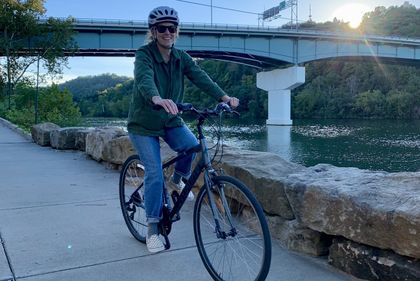 Participant biking along the Monongahela River in Morgantown, WV.